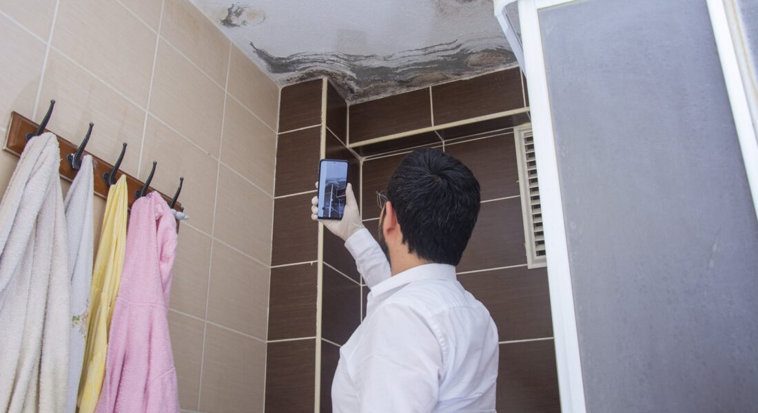 A Man Standing Next To A Sink
