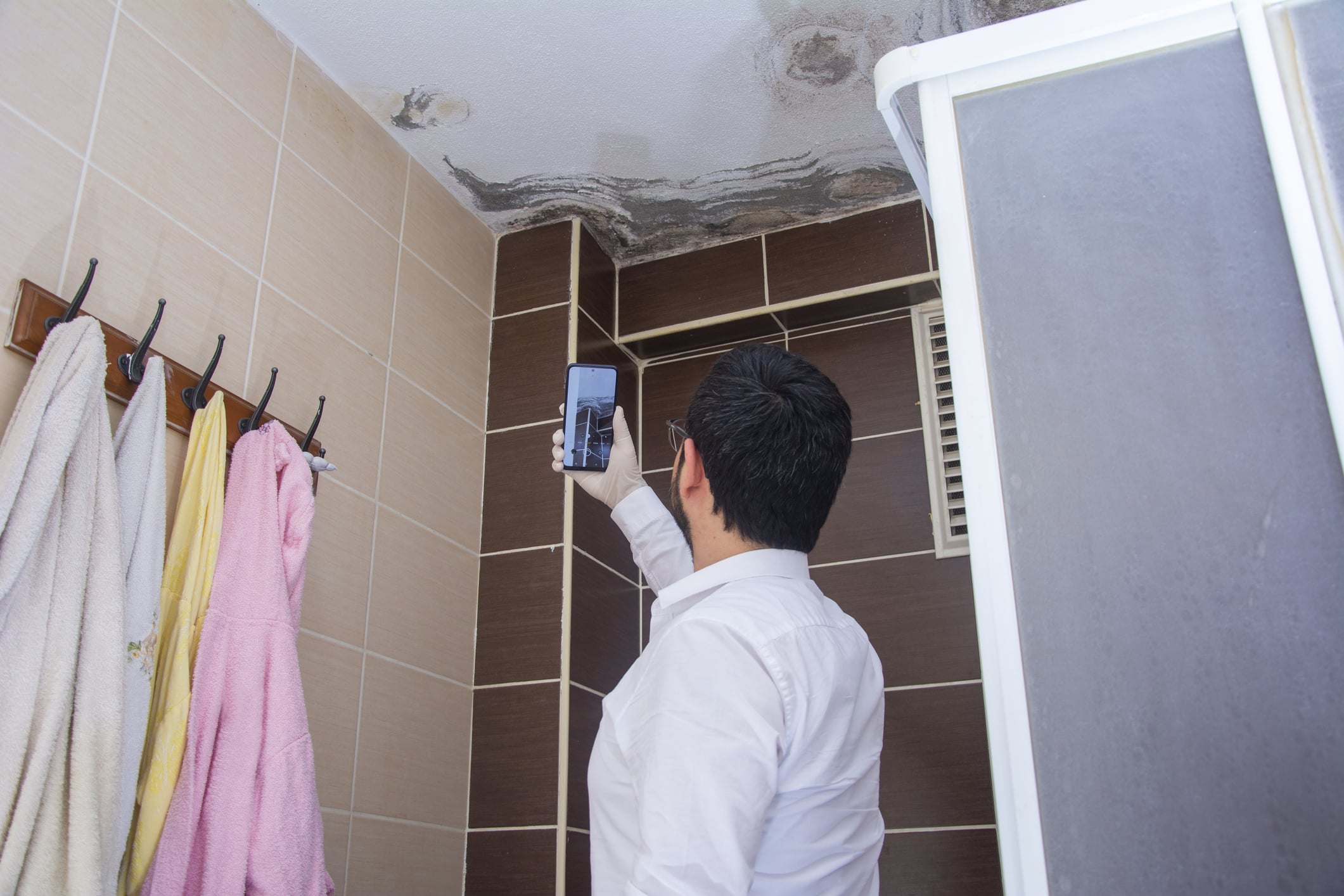 a man standing next to a sink