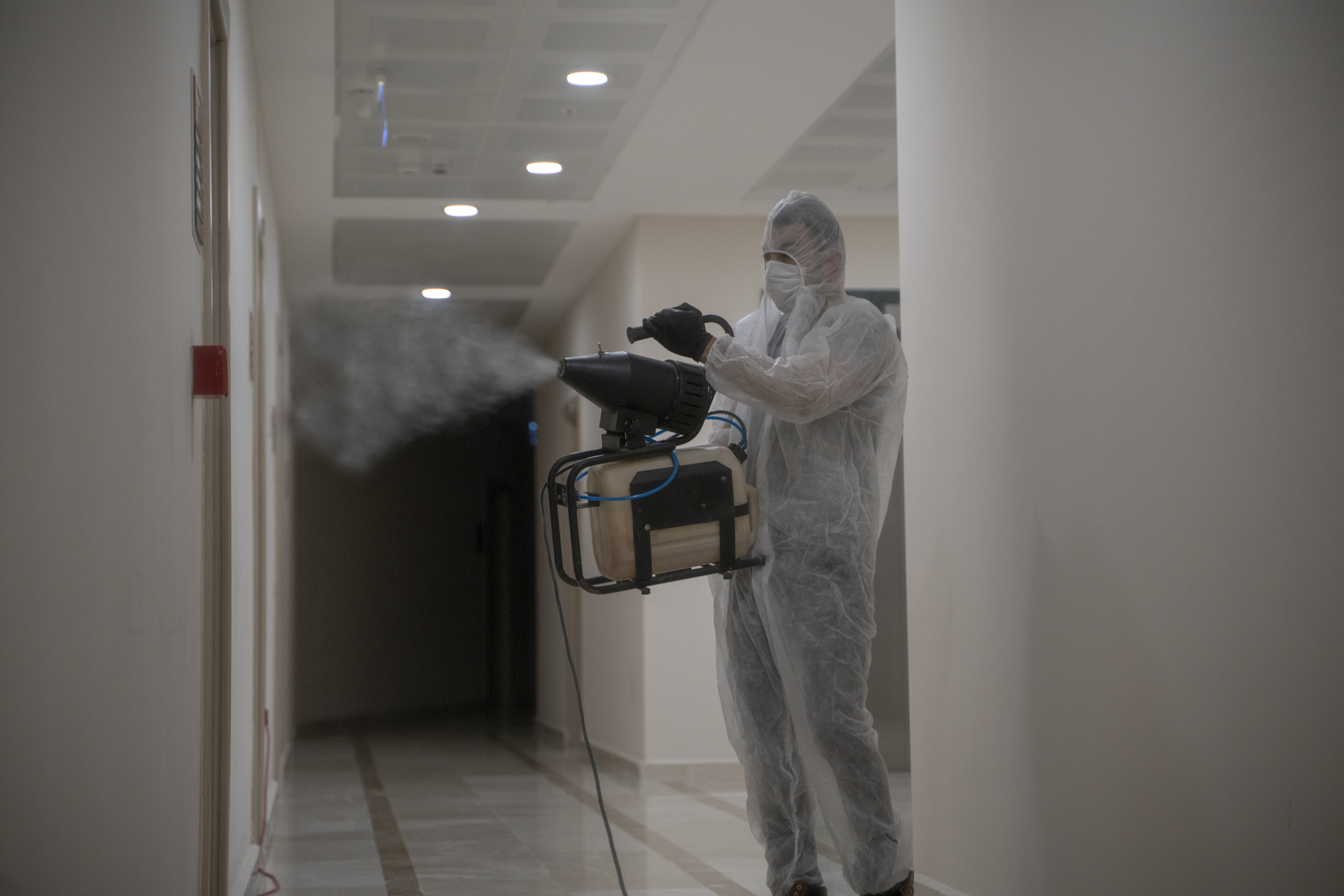 A technician sanitizing a contaminated area from harmful chemicals.